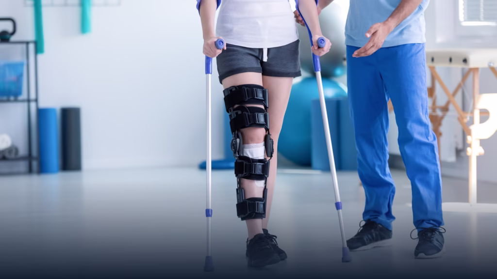 Personal Injury Claims Featured Image. Photo shows the lower half of two people, one with a brace around their leg being helped by a medical professional.